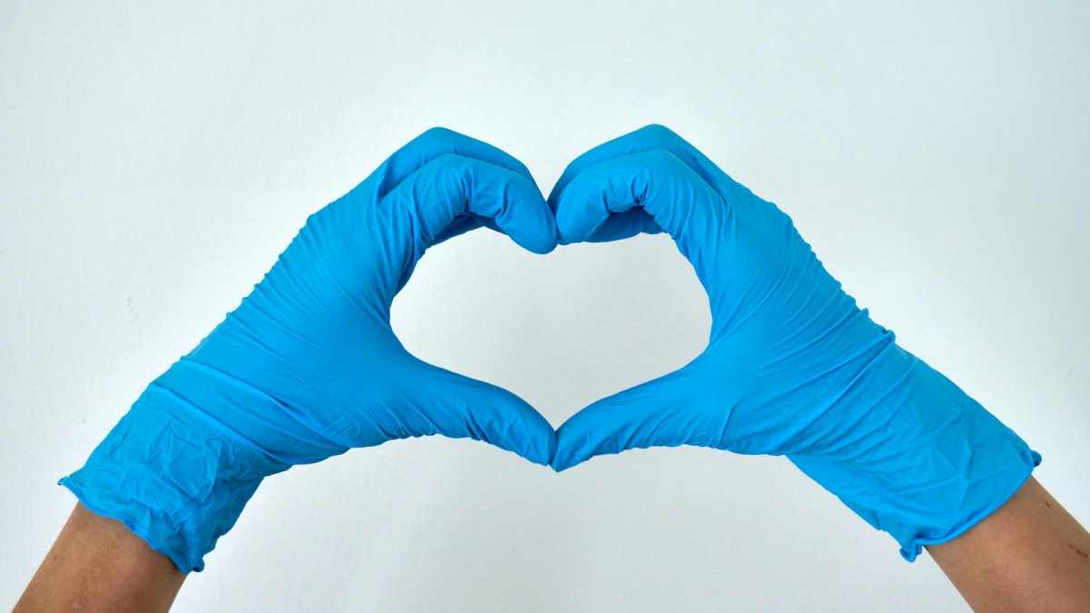 person in blue pants lying on white surface