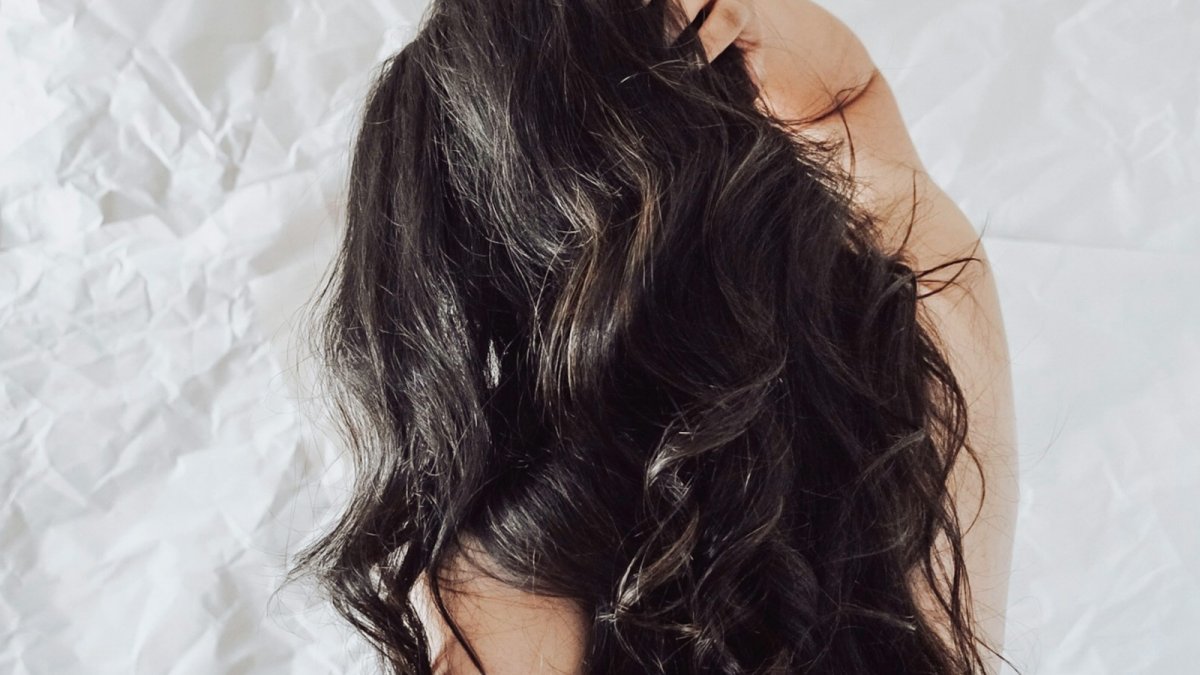 the back of a woman's head with long dark hair