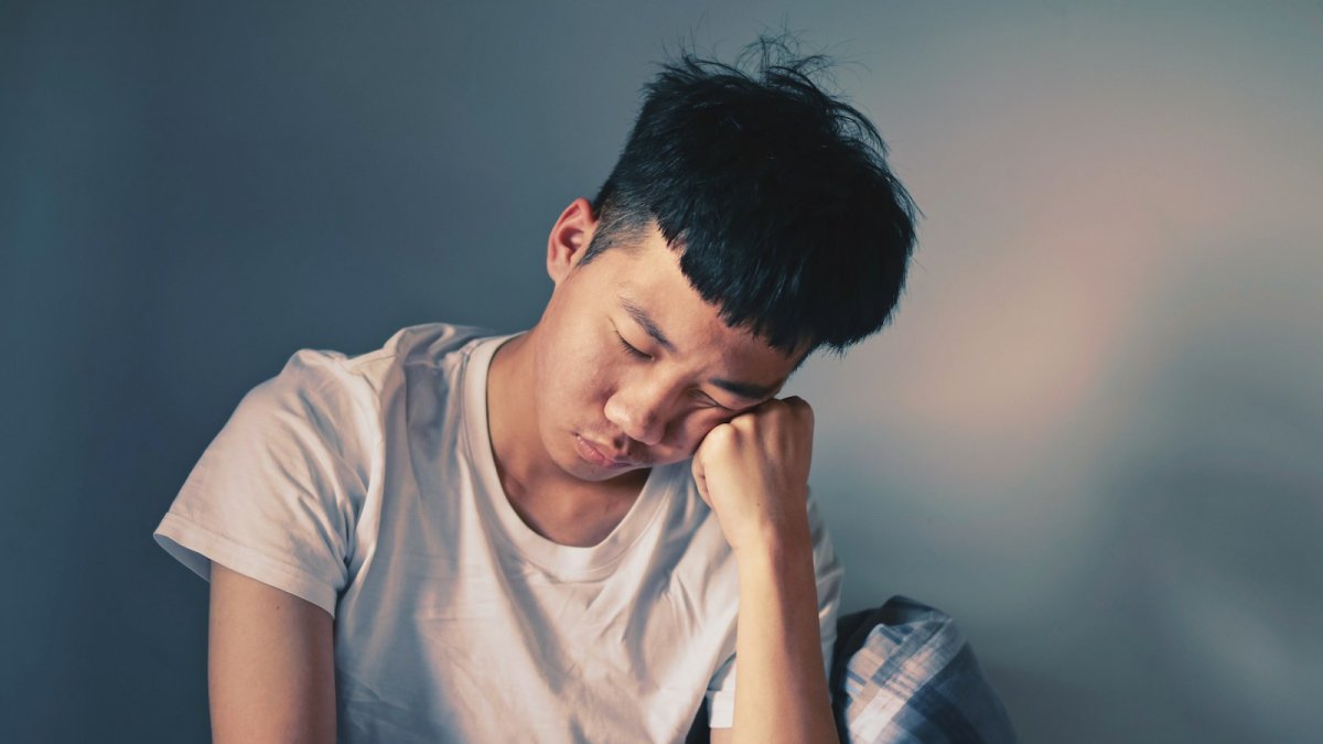 man resting his cheeks on hand